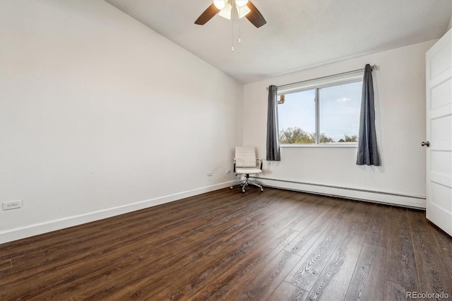 spare room with baseboard heating, ceiling fan, hardwood / wood-style floors, vaulted ceiling, and baseboards