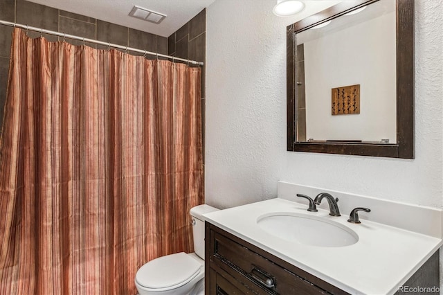 bathroom featuring a textured wall, toilet, vanity, and a shower with shower curtain