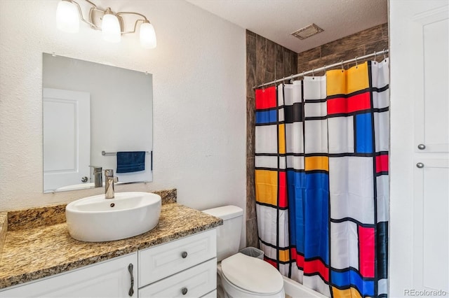 full bath featuring a shower with curtain, a textured wall, toilet, and vanity