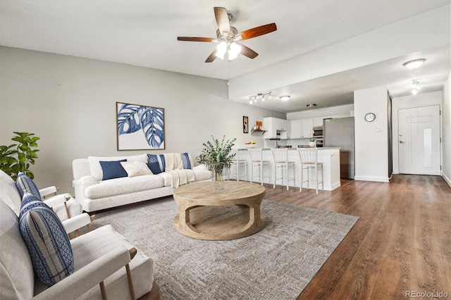 795 S Alton Way Unit 5D, Denver, CO 80247 - living area with a ceiling fan, dark wood-style flooring, track lighting, and baseboards