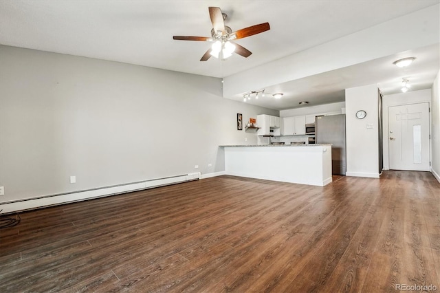 795 S Alton Way Unit 5D, Denver, CO 80247 - unfurnished living room featuring baseboard heating, ceiling fan, dark wood-type flooring, and baseboards