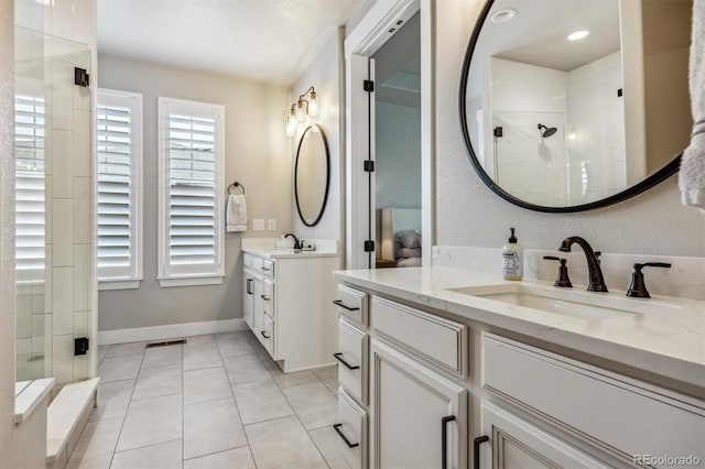 8890 S Quatar Ct, Aurora, CO 80016 - bathroom featuring a stall shower, tile patterned floors, two vanities, and baseboards