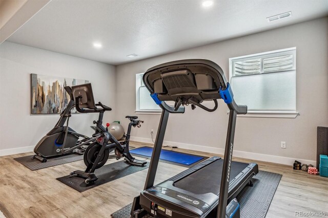 8890 S Quatar Ct, Aurora, CO 80016 - exercise area with baseboards, wood finished floors, and recessed lighting