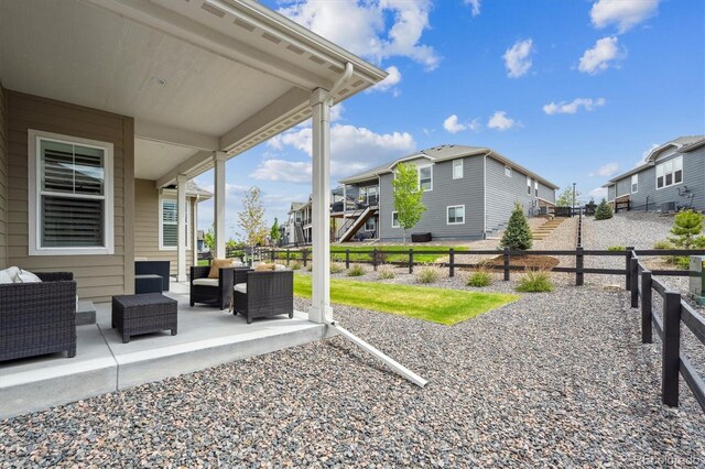 8890 S Quatar Ct, Aurora, CO 80016 - fenced backyard featuring outdoor lounge area, a residential view, and a patio area