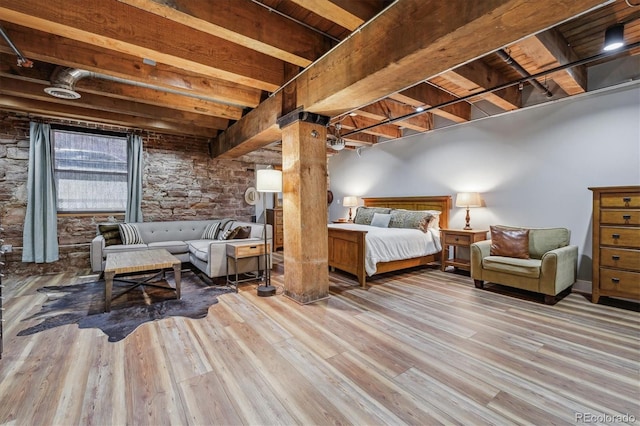 bedroom with beamed ceiling, ornate columns, light hardwood / wood-style floors, and wooden ceiling