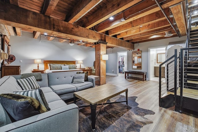 living room with wooden ceiling, rail lighting, light hardwood / wood-style flooring, and beam ceiling