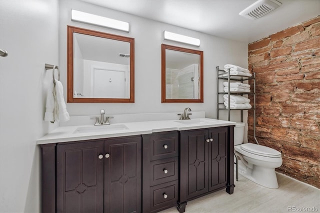 bathroom featuring wood-type flooring, toilet, and vanity