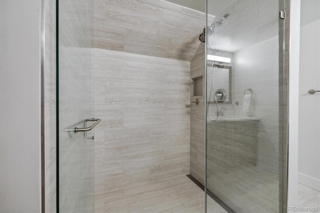 bathroom with a shower with shower door