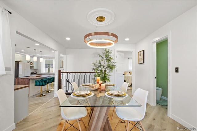 dining space with light wood-type flooring