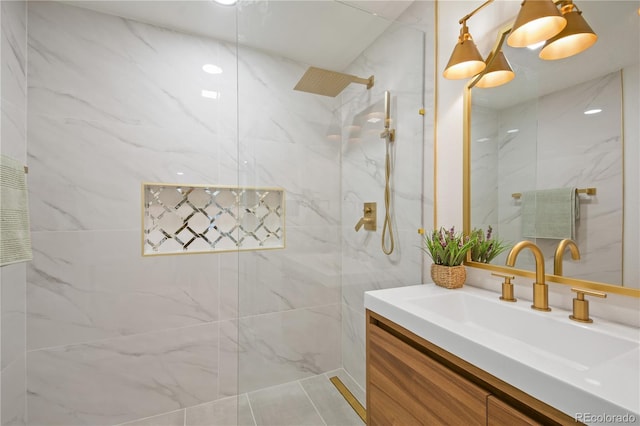 bathroom featuring vanity and tiled shower