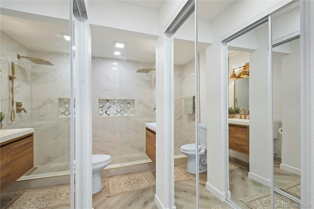 bathroom with toilet, vanity, and hardwood / wood-style floors