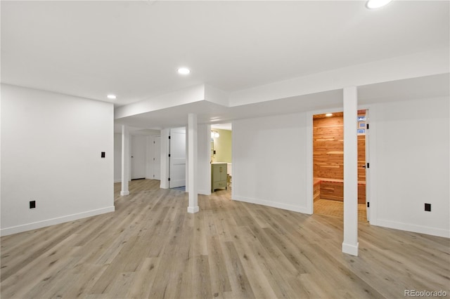 basement with light hardwood / wood-style flooring