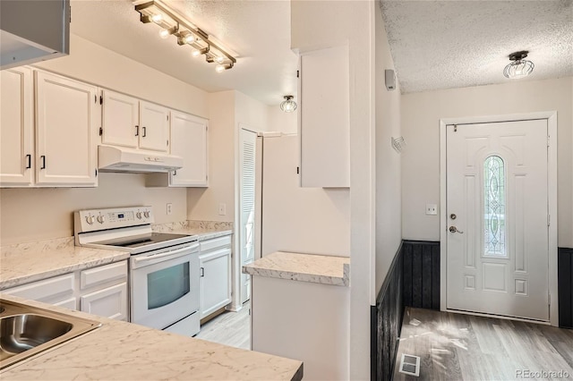 kitchen with sink, a textured ceiling, light wood-type flooring, white range with electric cooktop, and white cabinets