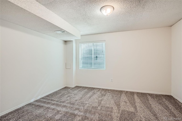 unfurnished room featuring carpet floors and a textured ceiling