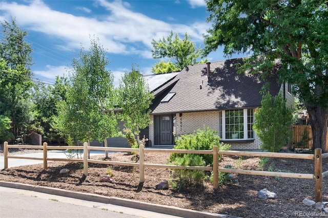 6097 S Jackson St, Centennial, CO 80121 - obstructed view of property featuring brick siding and solar panels