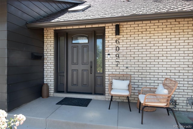 6097 S Jackson St, Centennial, CO 80121 - doorway to property featuring brick siding