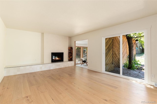 6097 S Jackson St, Centennial, CO 80121 - unfurnished living room featuring wood finished floors and a fireplace