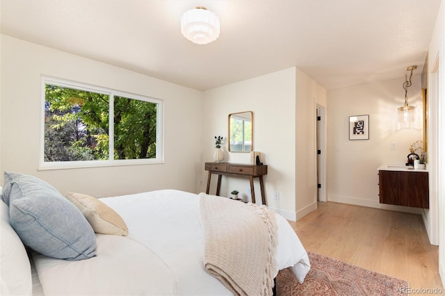 6097 S Jackson St, Centennial, CO 80121 - bedroom with light wood-style flooring and baseboards