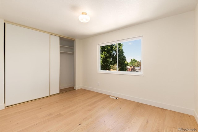 6097 S Jackson St, Centennial, CO 80121 - unfurnished bedroom with light wood-type flooring and a closet