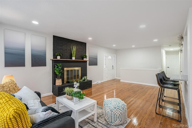 living room featuring a fireplace and hardwood / wood-style flooring