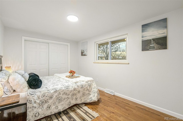 bedroom with a closet and hardwood / wood-style floors