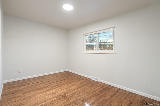 unfurnished room featuring hardwood / wood-style flooring