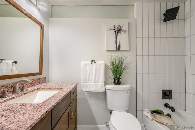 full bathroom with toilet, vanity, and tiled shower / bath