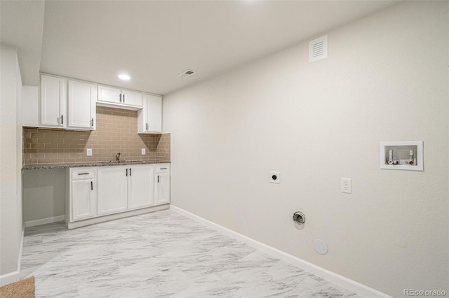 clothes washing area featuring gas dryer hookup, sink, and hookup for an electric dryer