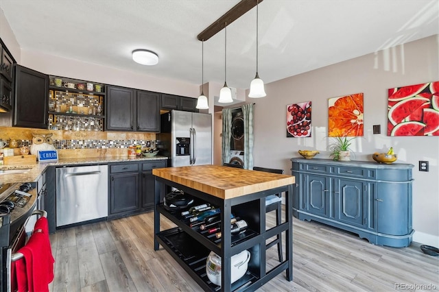 6495 E Happy Canyon Rd Unit 163, Denver, CO 80237 - kitchen featuring appliances with stainless steel finishes, light wood-style flooring, backsplash, pendant lighting, and open shelves