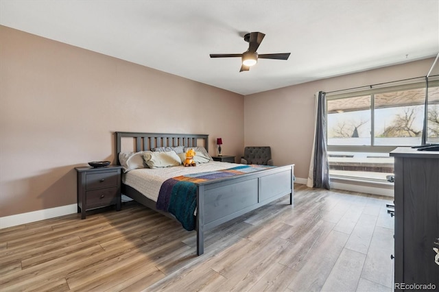6495 E Happy Canyon Rd Unit 163, Denver, CO 80237 - bedroom featuring light wood-type flooring, baseboards, and a ceiling fan