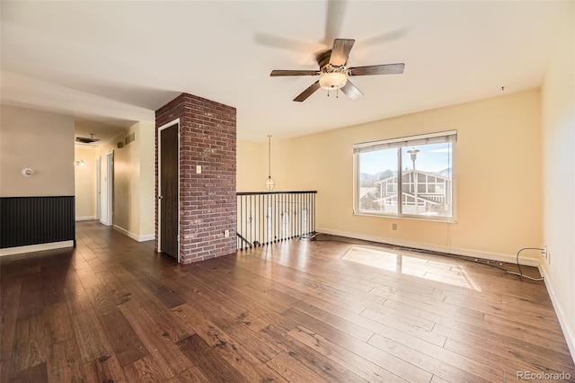 spare room featuring visible vents, ceiling fan, baseboards, and hardwood / wood-style flooring