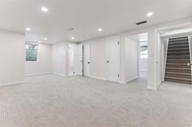 basement featuring recessed lighting, visible vents, light carpet, and stairs