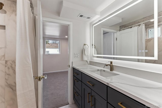 full bath with visible vents, baseboards, and vanity