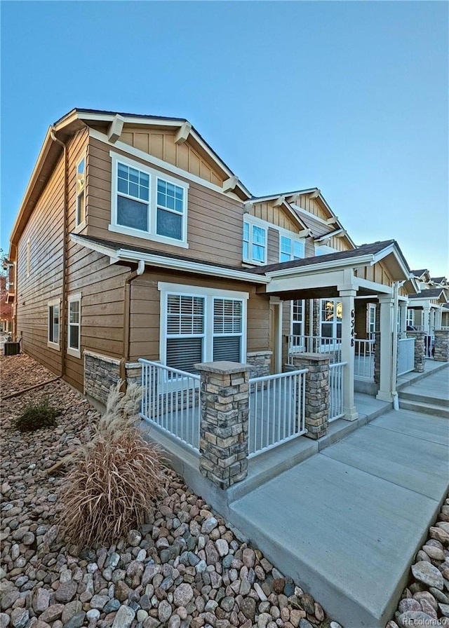 craftsman house with a porch and central AC