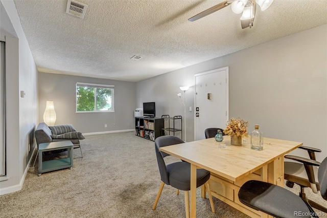 dining area with carpet, a textured ceiling, and ceiling fan