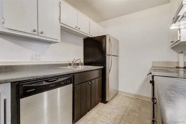 kitchen featuring appliances with stainless steel finishes, range hood, white cabinetry, and sink