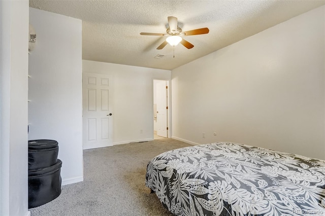 carpeted bedroom with ceiling fan and a textured ceiling