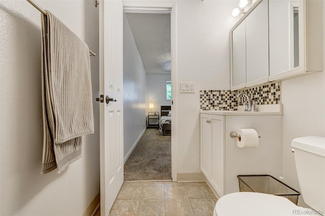 bathroom with decorative backsplash, toilet, and a textured ceiling