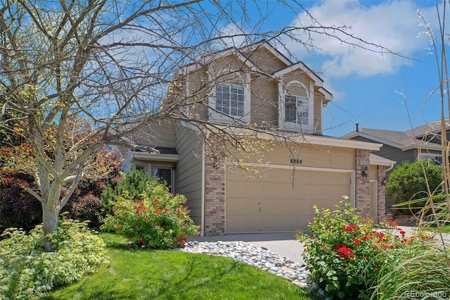8884 Miners St, Highlands Ranch, CO 80126 - view of front of house featuring brick siding, concrete driveway, and an attached garage