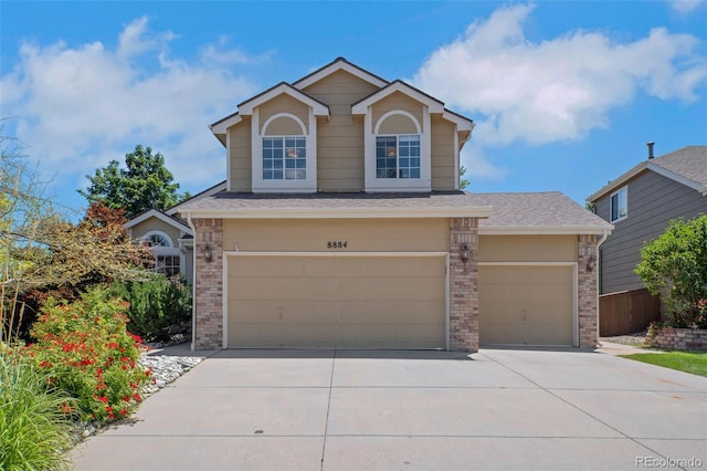8884 Miners St, Highlands Ranch, CO 80126 - traditional-style home with brick siding, driveway, a garage, and roof with shingles