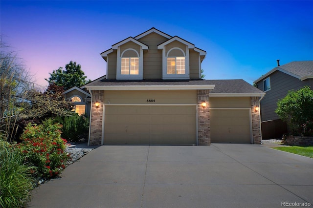 8884 Miners St, Highlands Ranch, CO 80126 - view of front of house featuring brick siding, driveway, and a garage