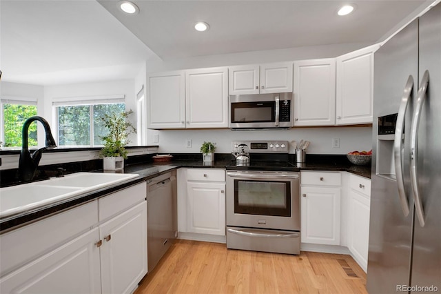 8884 Miners St, Highlands Ranch, CO 80126 - kitchen with stainless steel appliances, white cabinets, recessed lighting, and dark countertops