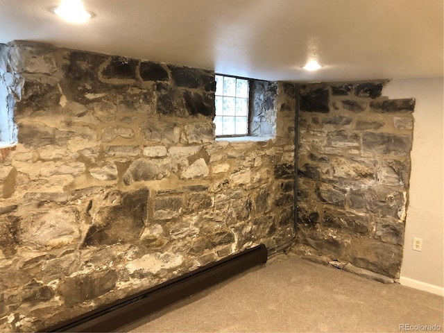 2335 Stout St, Denver, CO 80205 - below grade area featuring a baseboard heating unit and carpet