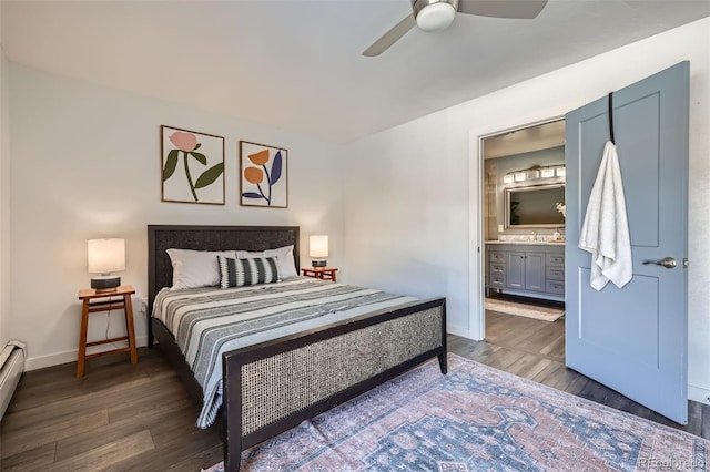 bedroom with ensuite bath, wood finished floors, baseboards, baseboard heating, and ceiling fan