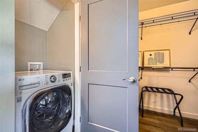 washroom with baseboards, washer / dryer, wood finished floors, and laundry area