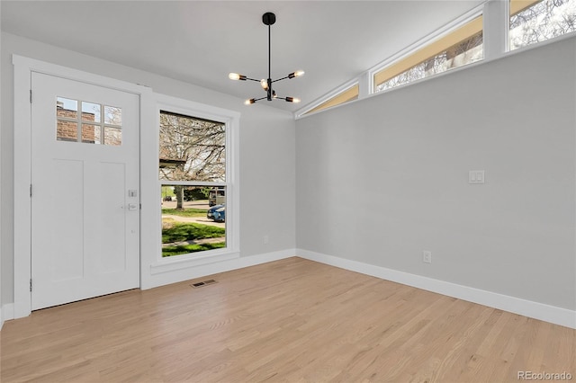 5373 S Prescott St, Littleton, CO 80120 - unfurnished dining area featuring a chandelier, light wood-style flooring, baseboards, and lofted ceiling