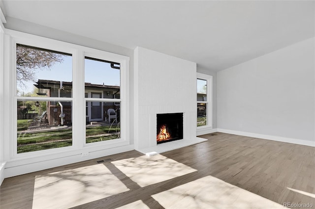 5373 S Prescott St, Littleton, CO 80120 - unfurnished living room with a large fireplace, wood finished floors, lofted ceiling, and baseboards