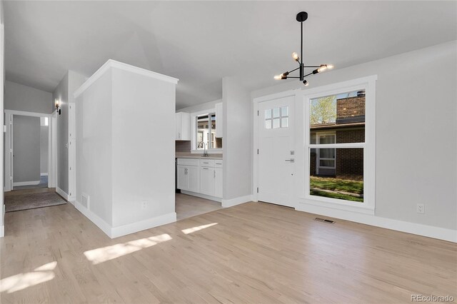 5373 S Prescott St, Littleton, CO 80120 - entryway with a chandelier, light wood finished floors, and baseboards
