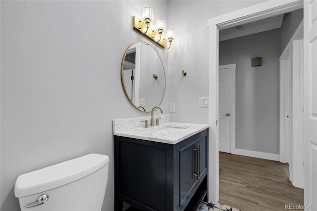5373 S Prescott St, Littleton, CO 80120 - bathroom featuring wood finished floors, vanity, toilet, a chandelier, and baseboards