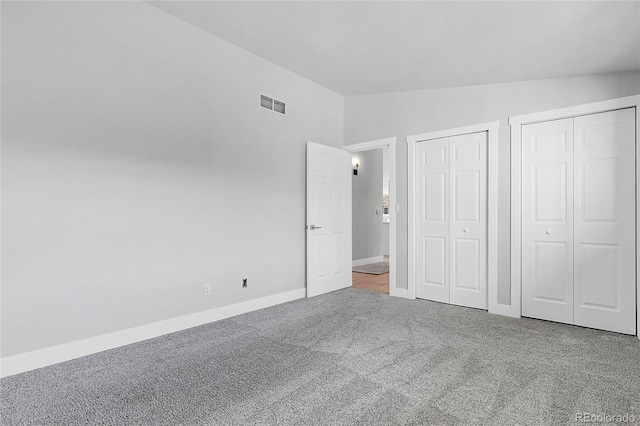 5373 S Prescott St, Littleton, CO 80120 - unfurnished bedroom with two closets, carpet, lofted ceiling, and baseboards